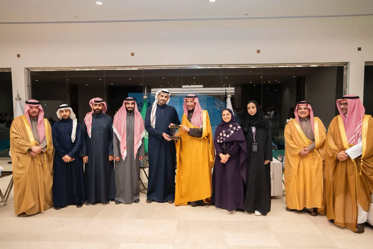 A delegation stands for a group photograph in the venue lobby at the agri-food forum, with an award held at the centre.