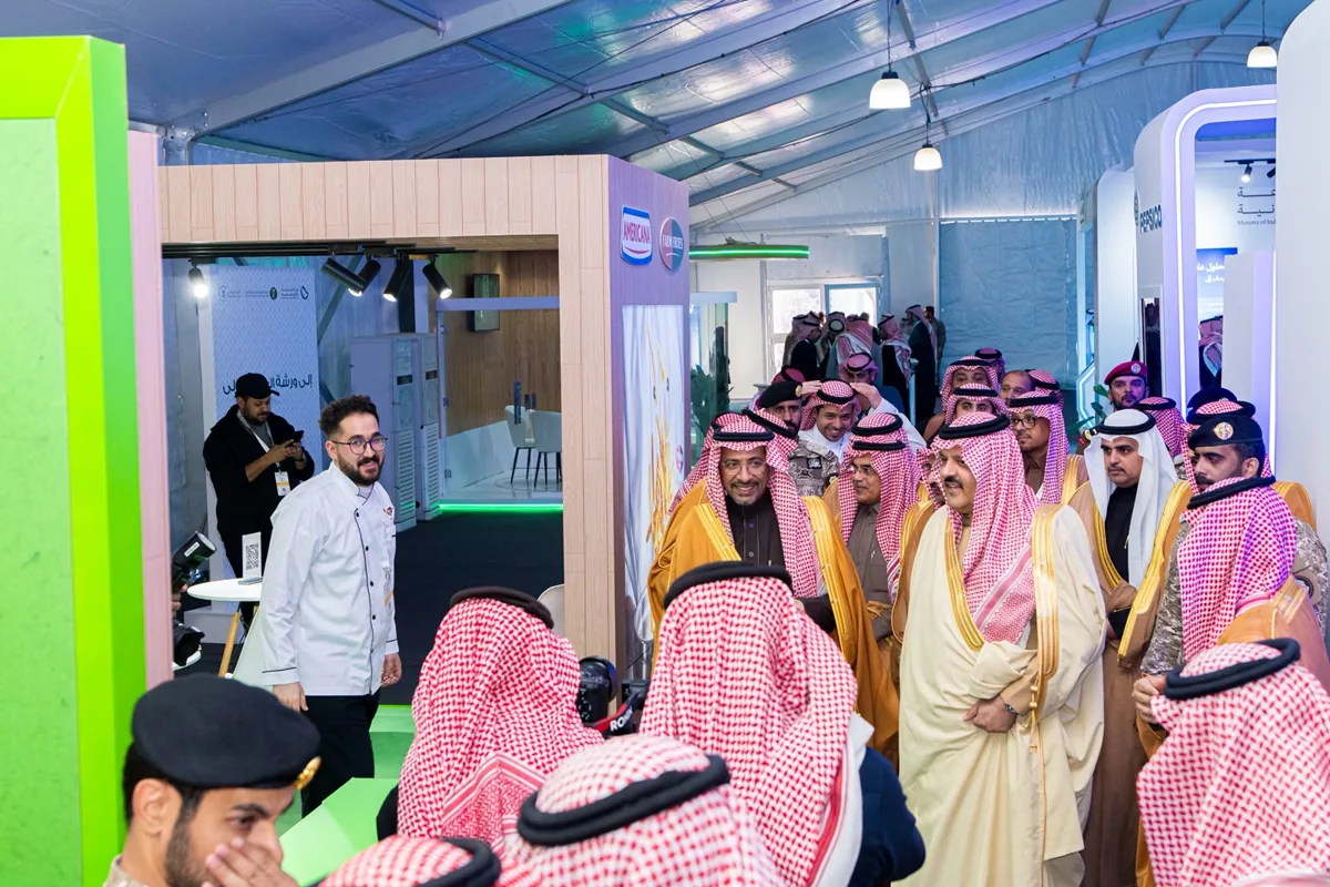 Officials on the VIP tour walk past the Americana and PepsiCo pavilions at the agri-food forum.