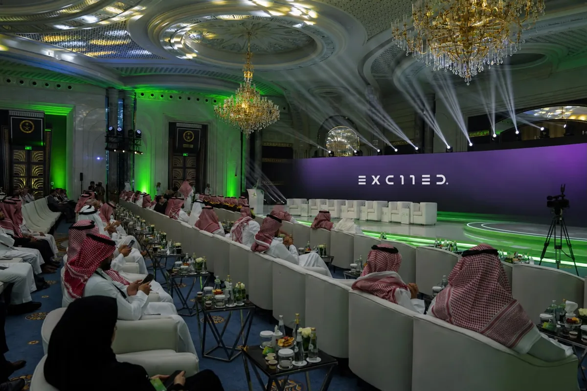 The Excited LED stage and the seated guests in the chandelier ballroom at the ministerial launch ceremony.