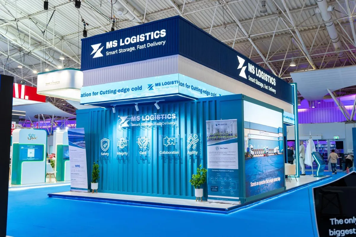 The container-form front of the MS Logistics stand, with the company's values printed on the corrugated wall.